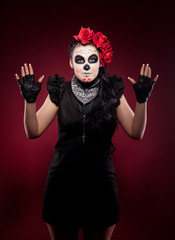 funny woman in day of the dead mask smile on red