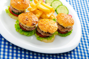 Plate with tasty mini burgers