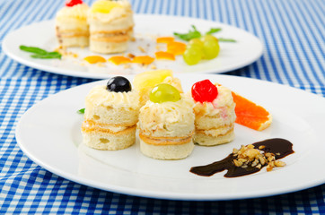 Plate full of tasty mini cakes