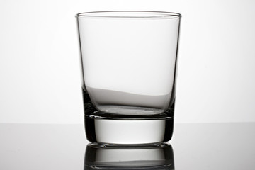 An empty glass on a grey background