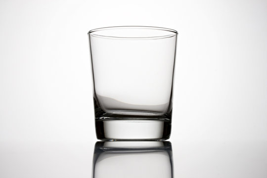 An empty glass on a grey background