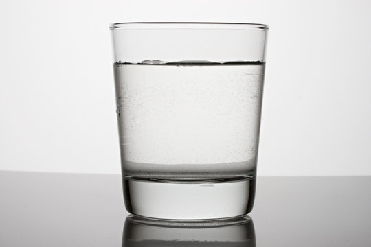 Glass of water on a grey background