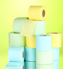 bright rolls of toilet paper on green background