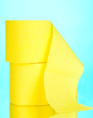 two yellow rolls of toilet paper on blue background