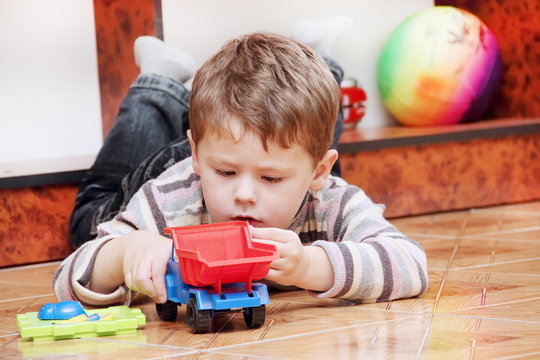 Boy Playing with Toy Truck