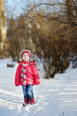 Little girl having fun at winter day