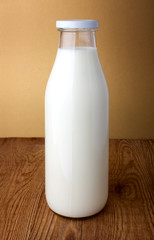 Bottle of milk  on wooden background.