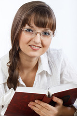 Beautiful Smiling girl reading a book