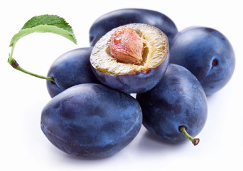Group of plums with leaf.