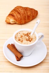 Hot coffee with cinnamon sticks