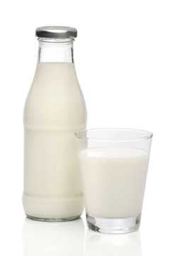 Milk bottle and a glass. With clipping path