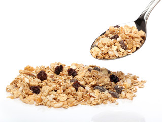 Granola cereals on a spoon over white background