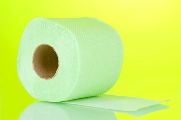 green roll of toilet paper on green background