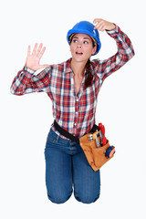 A female construction worker trapped in an invisible box.