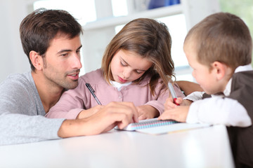 Man helping kids with homework