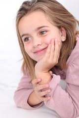 Portrait of cute little girl with hands on chin