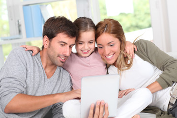 Family using electronic tablet at home