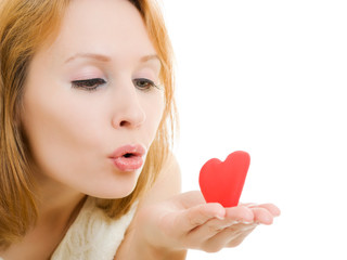 The girl sends an air kiss on a white background.