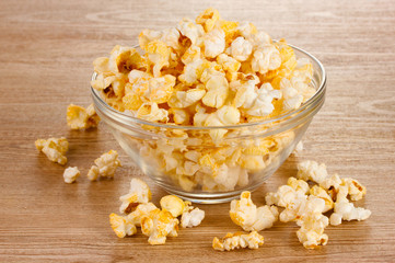 popcorn in glass bowl on wooden table