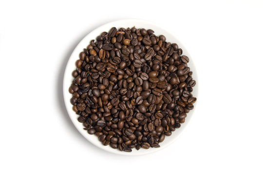 Coffee beans on the white plate