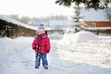 Fototapeta na wymiar Little girl having fun at winter day