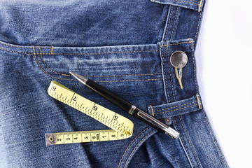 Measuring tape on front blue jeans