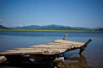 Old wooden dangerous bridge on the seashore