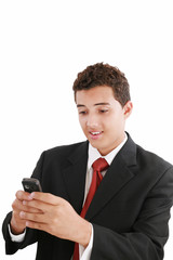 A handsome young business man texting on his phone