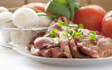 Fresh raw pork with fresh, vegetables.