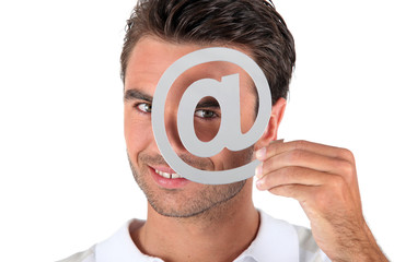 Man covering eye with at symbol