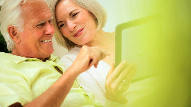 Retired Couple Using Wireless Tablet Technology