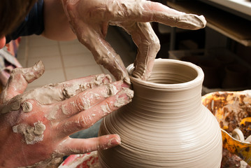 potter creating earthen jar on the circle
