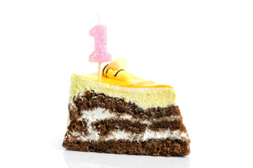 Slice of cream birthday cake with number one candle