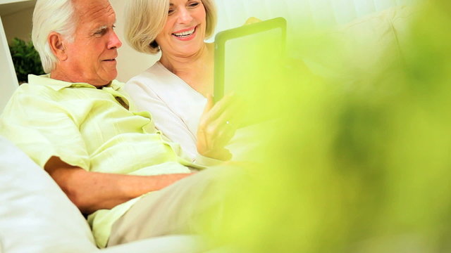 Mature Couple Using a Wireless Tablet at Home