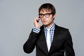 Handsome young man in glasses with mobile phone