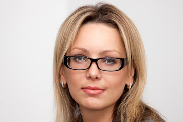 Fototapeta premium Portrait of blonde woman in glasses with long hair