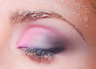 Naklejka premium Closed eye with snowy makeup