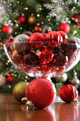 Christmas ornaments on table in front of tree - 37337814