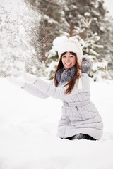 young woman throwing snow