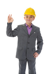 Little smiling builder in helmet