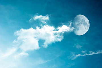 Naklejka na ściany i meble Moon between the clouds