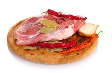 Raw meat and vegetables on a wooden board isolated on whitе