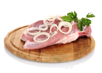 Raw meat and onion on a wooden board isolated on white