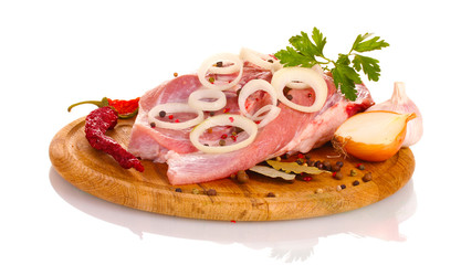 Raw meat and onion on a wooden board isolated on white