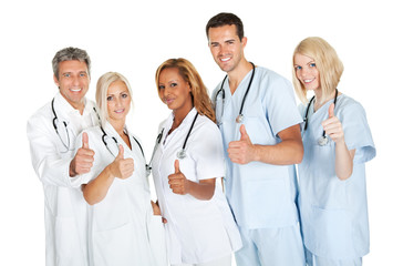 Friendly group of doctors with thumbs up on white