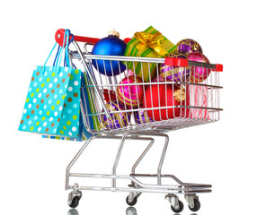 Beautiful bright Christmas balls and gifts in the cart