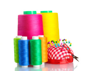 Bobbins of thread with colored pinheads in pin-cushion isolated