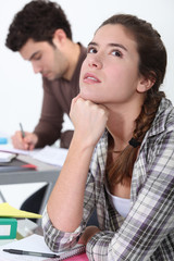 Young woman daydreaming in class