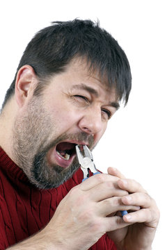 Man pulling his own tooth