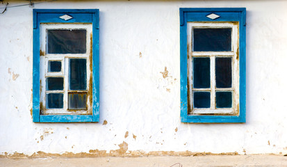 two windows old clay wall